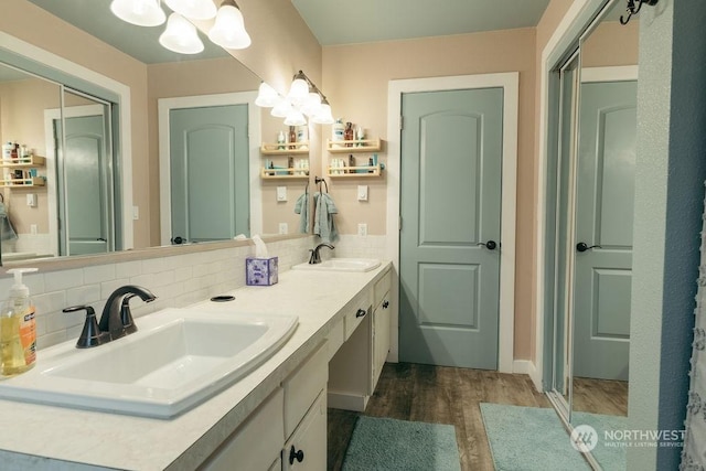 bathroom featuring decorative backsplash, vanity, and wood-type flooring