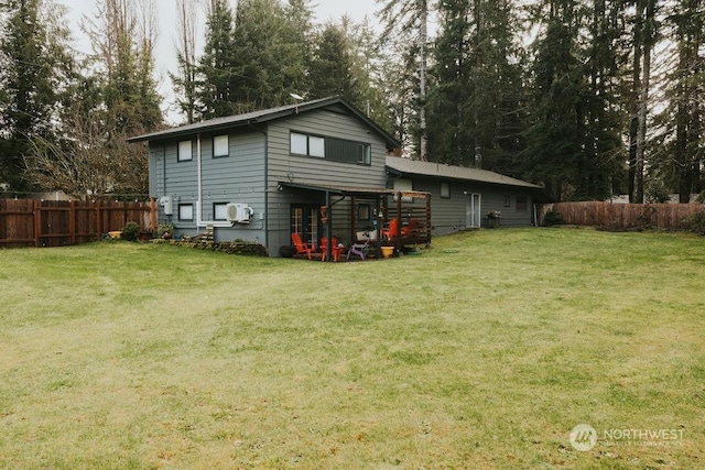 back of house featuring a yard