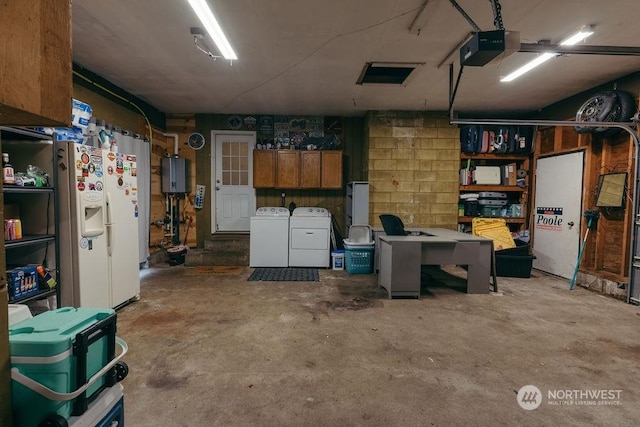 garage featuring water heater, washer and dryer, white refrigerator with ice dispenser, and a garage door opener