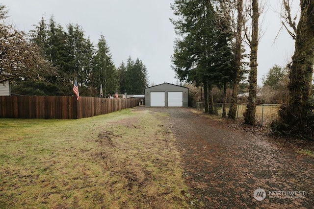 view of yard featuring an outdoor structure and a garage