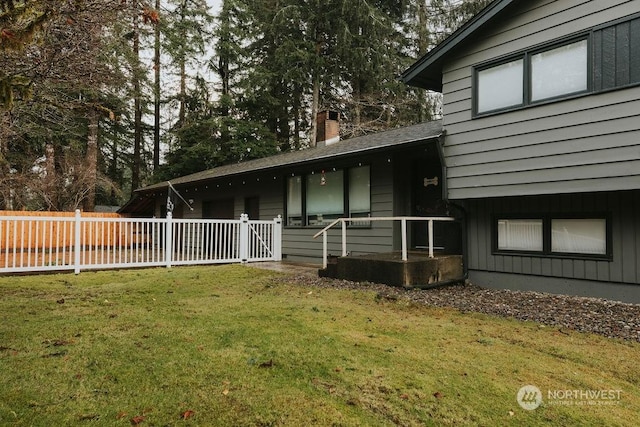 rear view of house with a lawn