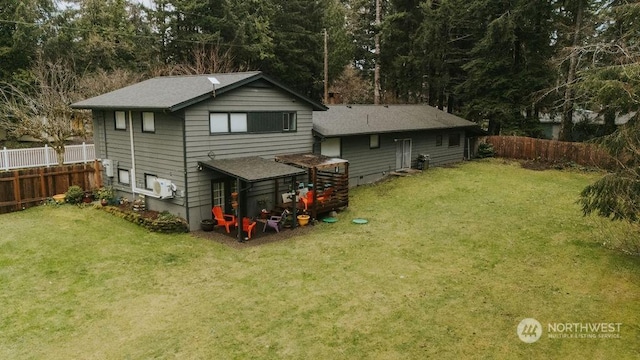 back of house featuring a lawn