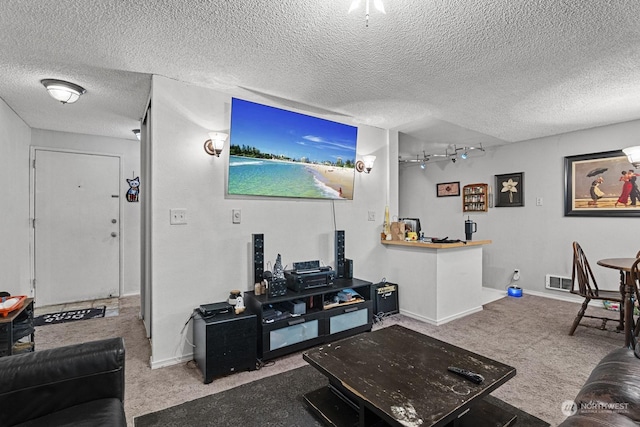 living room with carpet floors and a textured ceiling