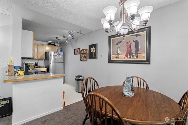 dining area featuring light colored carpet, a notable chandelier, and a textured ceiling