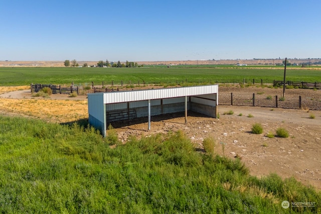 exterior space featuring a rural view and an outdoor structure