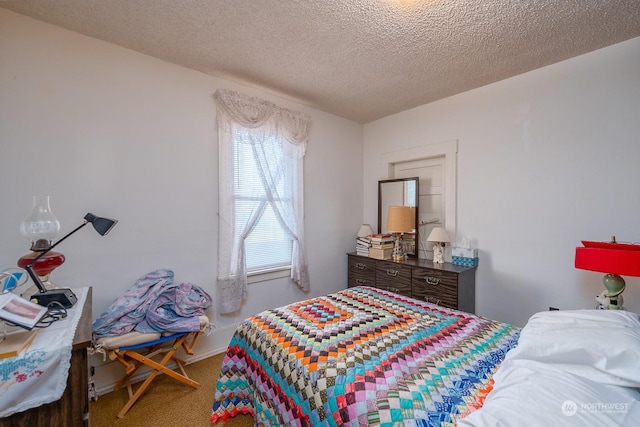 bedroom with carpet and a textured ceiling