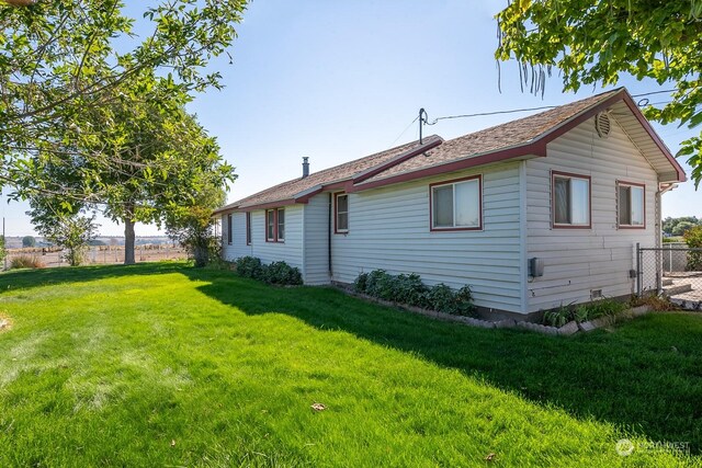 rear view of house with a lawn