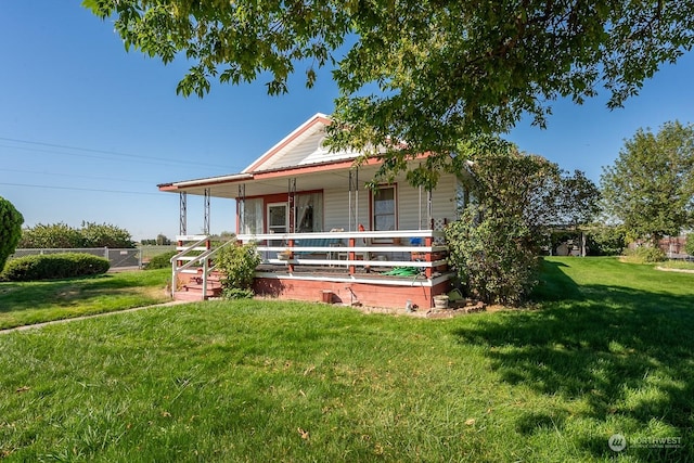 country-style home with a porch and a front lawn