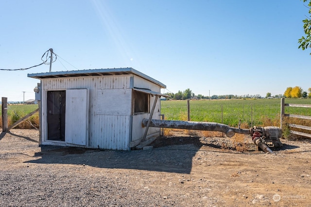 view of outdoor structure with a rural view