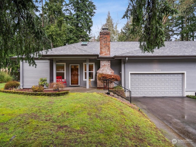 ranch-style house with a garage and a front yard