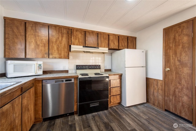 kitchen featuring decorative backsplash, white appliances, and dark hardwood / wood-style floors