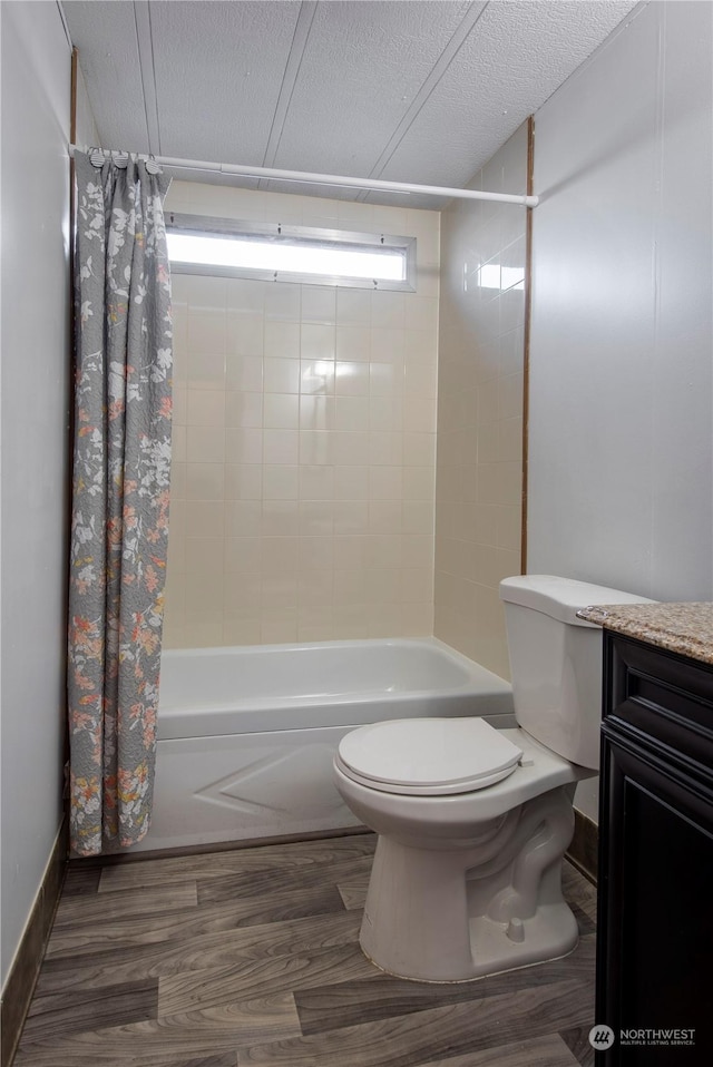 full bathroom with a textured ceiling, vanity, toilet, hardwood / wood-style flooring, and shower / bath combo