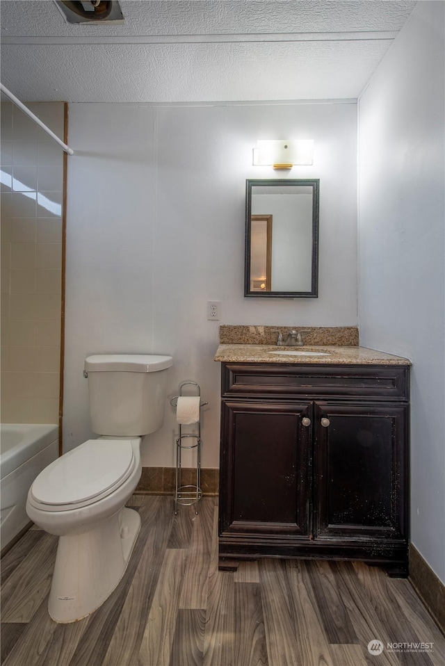 full bathroom with toilet, vanity, shower / bathing tub combination, and hardwood / wood-style floors