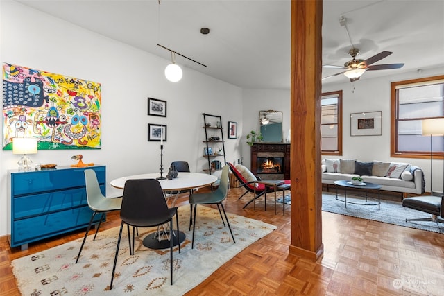 dining area with ceiling fan and parquet floors