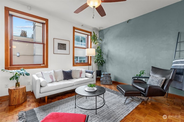 living room featuring ceiling fan and parquet floors