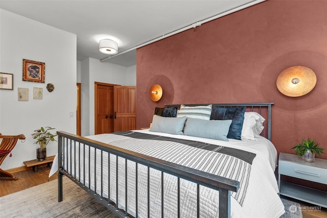 bedroom with wood-type flooring