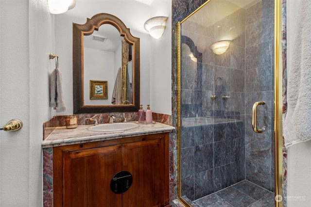 bathroom with a shower with door and vanity