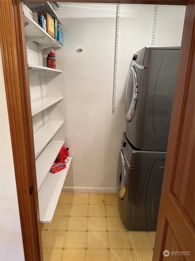 laundry area with stacked washing maching and dryer