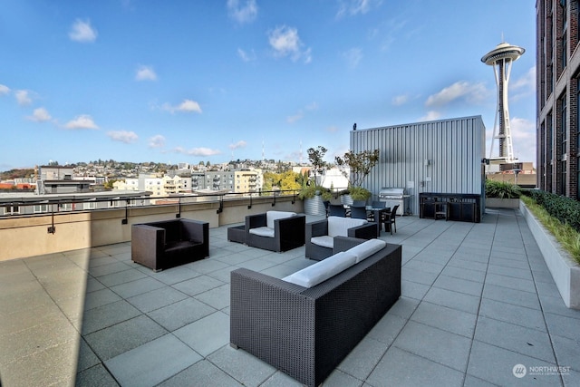 view of patio with an outdoor living space, area for grilling, and exterior kitchen