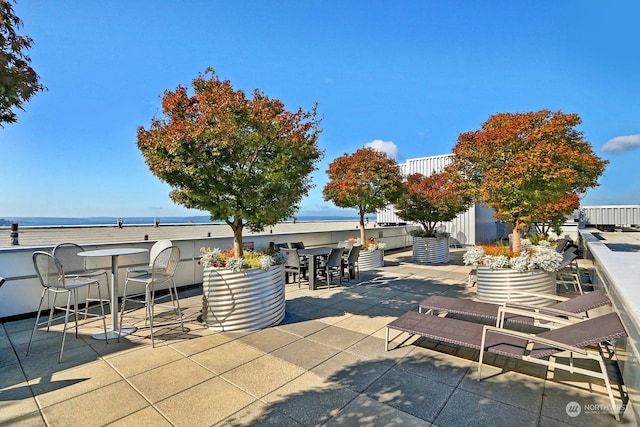 view of patio with a water view