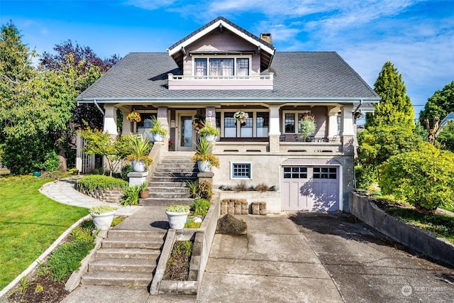 view of front of house with a porch, a balcony, a front yard, and a garage