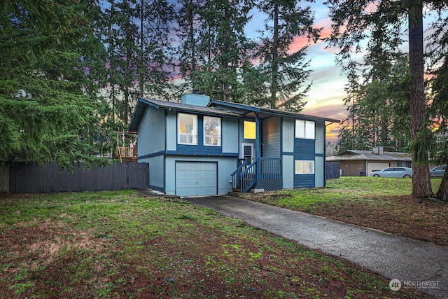 split foyer home with a lawn and a garage