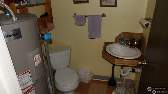 bathroom featuring sink, toilet, and water heater