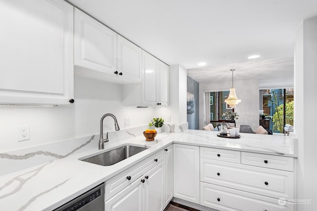 kitchen with white cabinets, pendant lighting, and sink