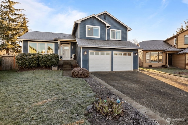 view of front of home featuring a garage and a front lawn