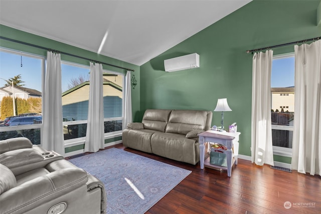 living room featuring a healthy amount of sunlight, dark wood-type flooring, a wall mounted AC, and vaulted ceiling