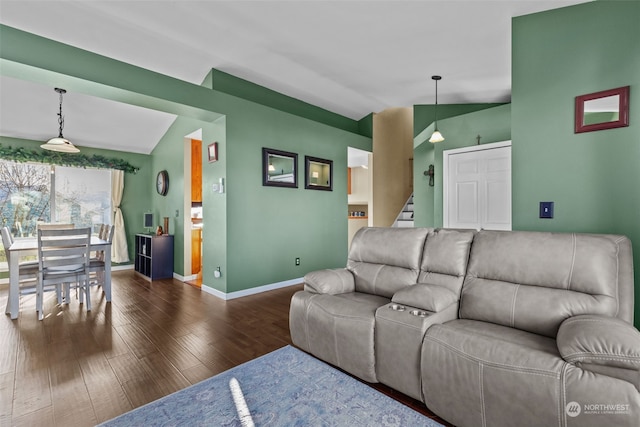 living room featuring dark hardwood / wood-style flooring and lofted ceiling