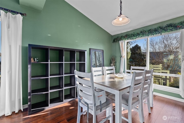 dining room with dark hardwood / wood-style flooring and vaulted ceiling