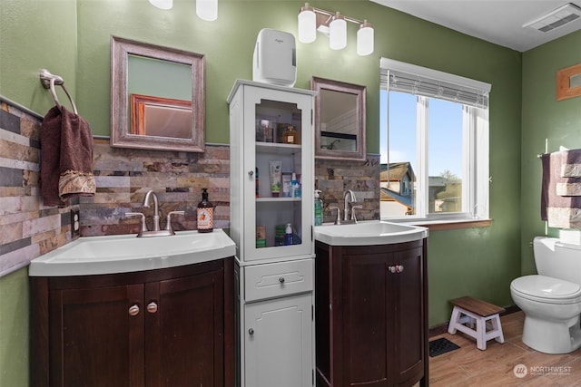 bathroom featuring vanity, hardwood / wood-style floors, and toilet