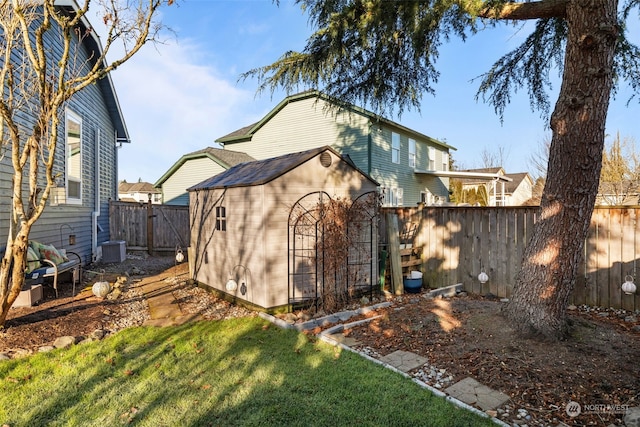 view of outbuilding featuring central AC unit and a lawn