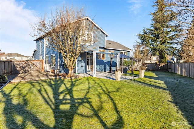 rear view of property with a patio area and a lawn