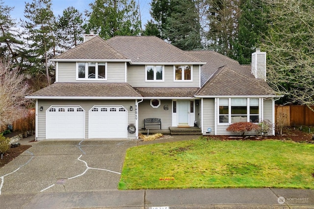 view of property with a front lawn and a garage