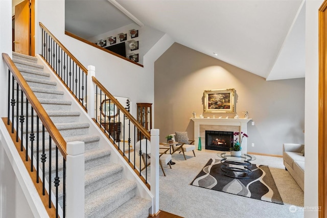 living room featuring carpet flooring, a fireplace, and lofted ceiling