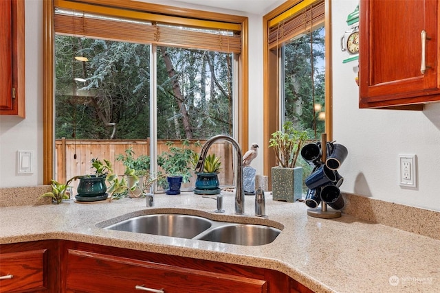 kitchen with light stone counters and sink