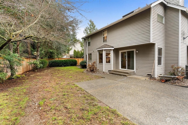 rear view of property featuring a patio area and a yard