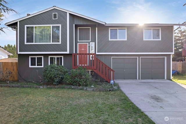 split foyer home with a garage and a front yard