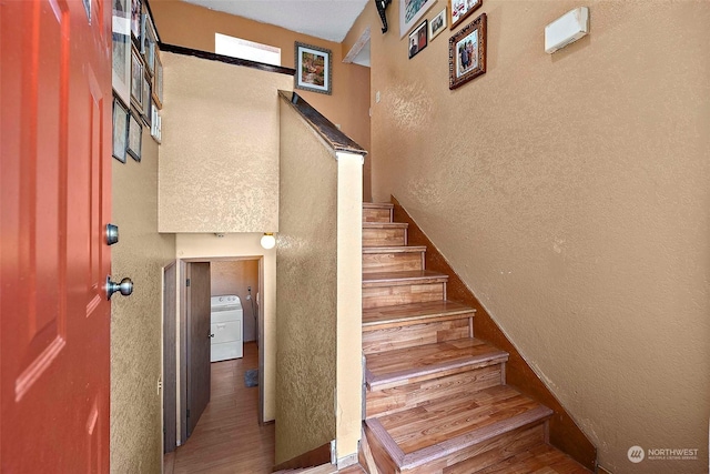 staircase featuring washer / dryer