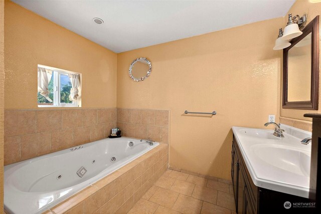 bathroom with vanity, tile patterned floors, and tiled tub