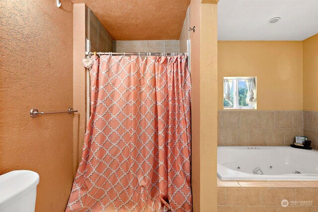 bathroom featuring separate shower and tub and toilet