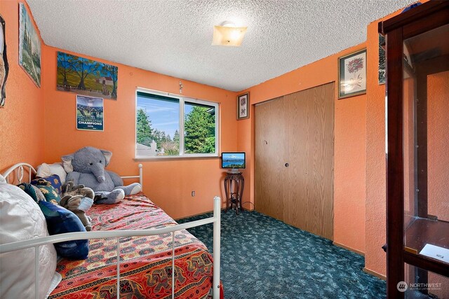 carpeted bedroom with a textured ceiling