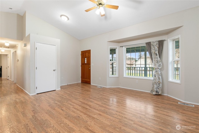 unfurnished room featuring ceiling fan, vaulted ceiling, and light hardwood / wood-style flooring