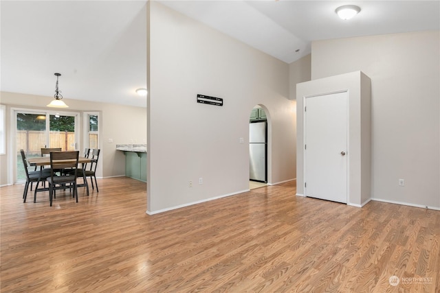 living room with lofted ceiling and light hardwood / wood-style flooring