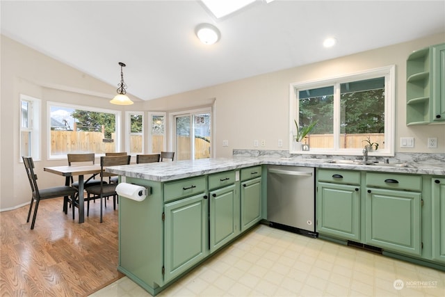 kitchen featuring kitchen peninsula, sink, decorative light fixtures, green cabinetry, and dishwasher