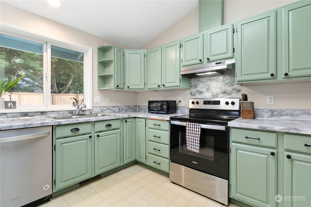 kitchen with stainless steel appliances, vaulted ceiling, tasteful backsplash, and sink