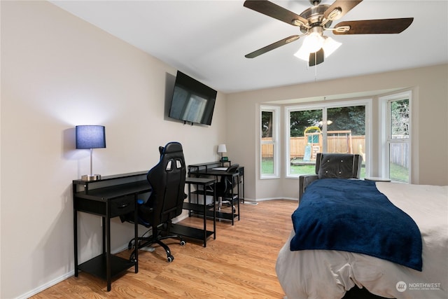 bedroom with light hardwood / wood-style flooring and ceiling fan