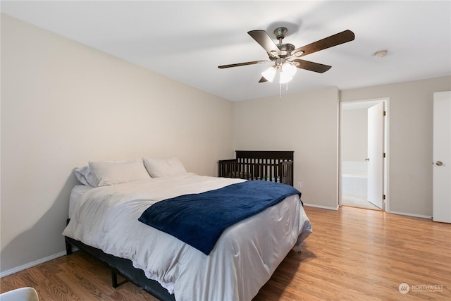 bedroom with hardwood / wood-style floors, ensuite bath, and ceiling fan